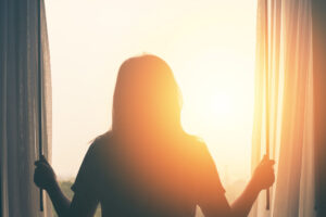 Female looking out the window to a brighter future after bankruptcy filing