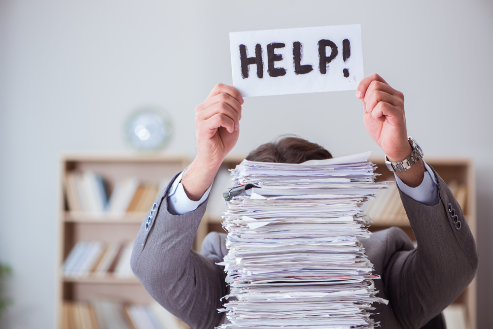 man stressed with paperwork