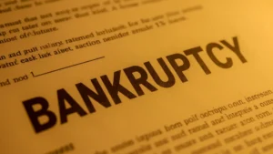 A close-up shot reveals the word 'BANKRUPTCY' prominently displayed on a yellowish legal document